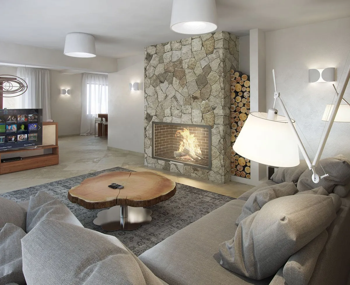 Living room featuring a stone fireplace, grey sofa, wood slice table, and TV.
