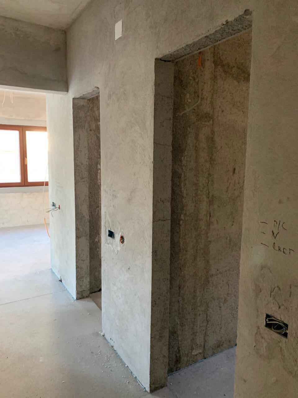 Shell interior finish of a villa in Dobrota, Montenegro: concrete walls and door openings in a property under construction.