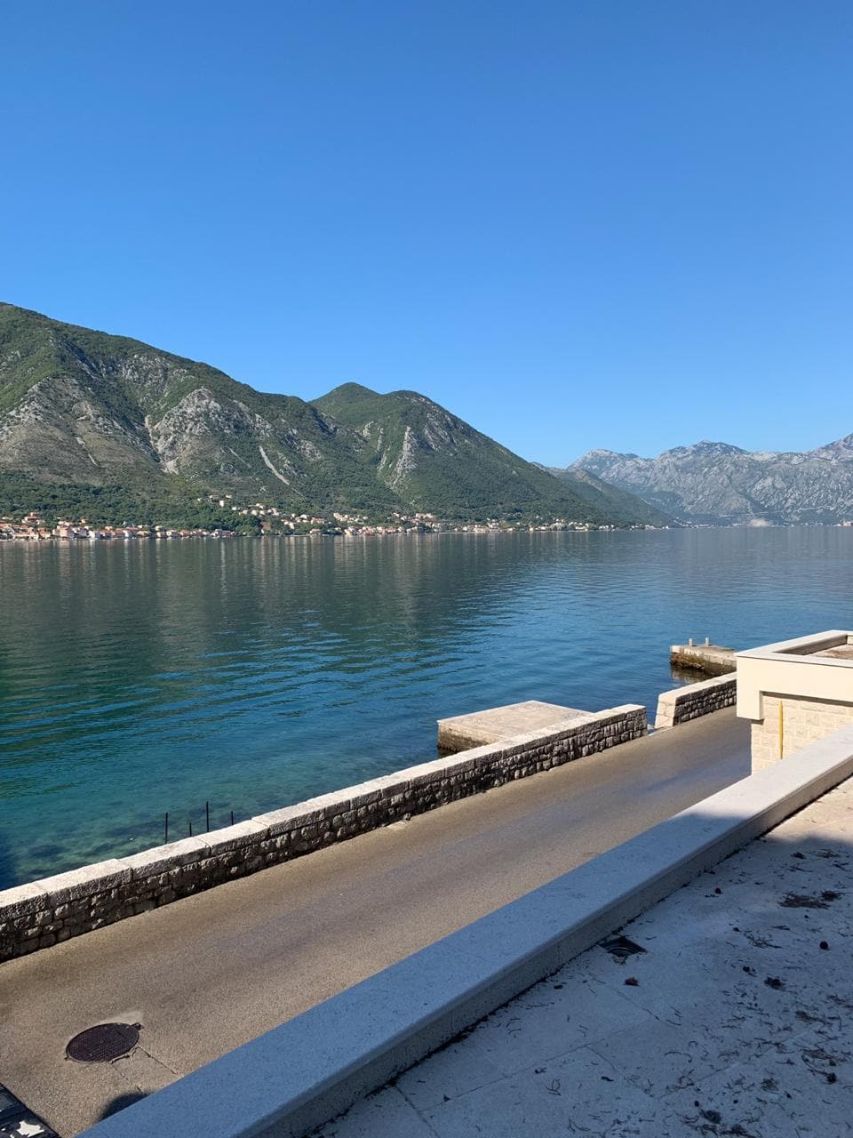 Panoramic view of the Bay of Kotor and the mountains from the villa terrace in Dobrota, Montenegro. Seafront promenade.
