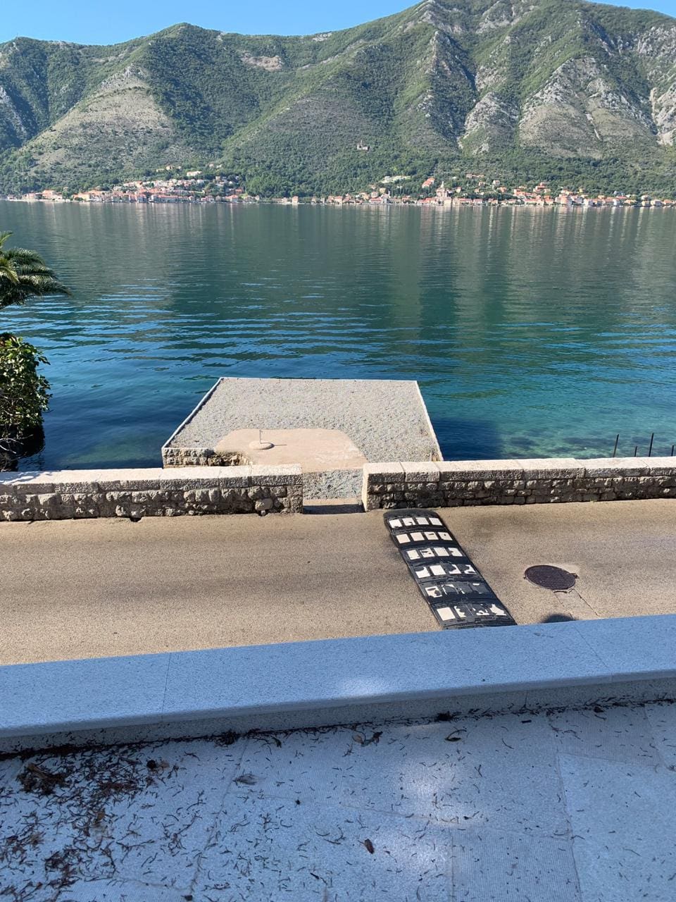 Sea view and private pier at a villa in Dobrota, Montenegro: panoramic view of Kotor Bay and mountain scenery.