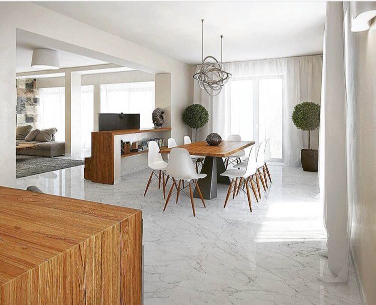 Modern living room with dining area in a villa in Dobrota, Montenegro: marble floor, wooden table, and decor.