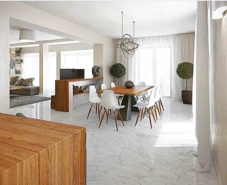 Modern living and dining area with marble floors, wooden table, white chairs, and sofa in background.