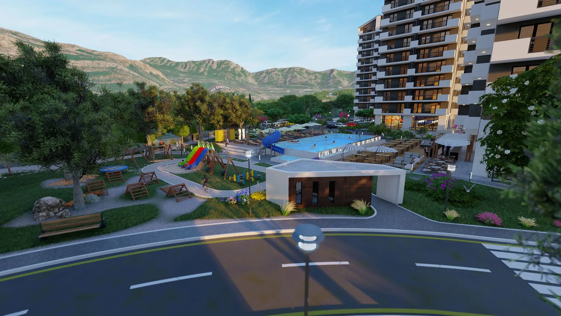 Overview of a resort complex featuring a pool, playground, apartment building, and mountains.