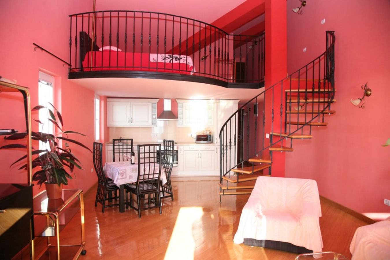 Two-level living room with a spiral staircase and sleeping area on the mezzanine, villa in Tivat, Montenegro.