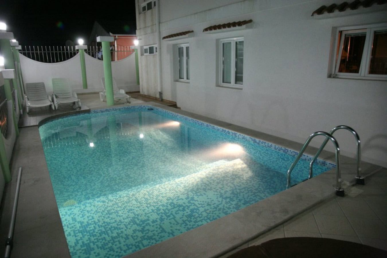 Private pool with lighting and sun loungers on the villa grounds in Tivat, Montenegro.