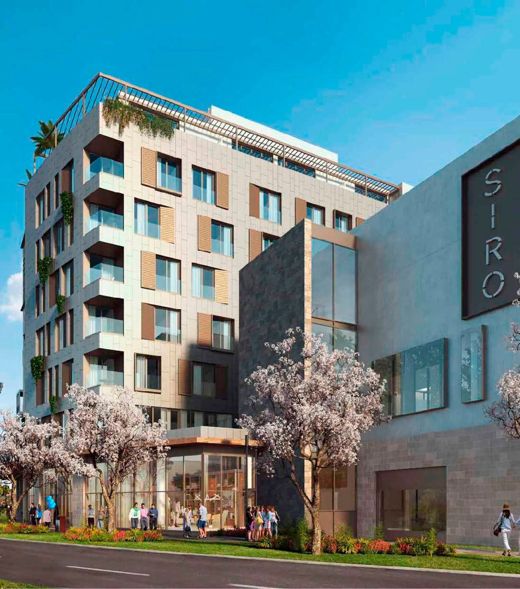 Modern SIRO hotel in Boka Place, Tivat, Montenegro: building facade with panoramic windows and blooming trees.