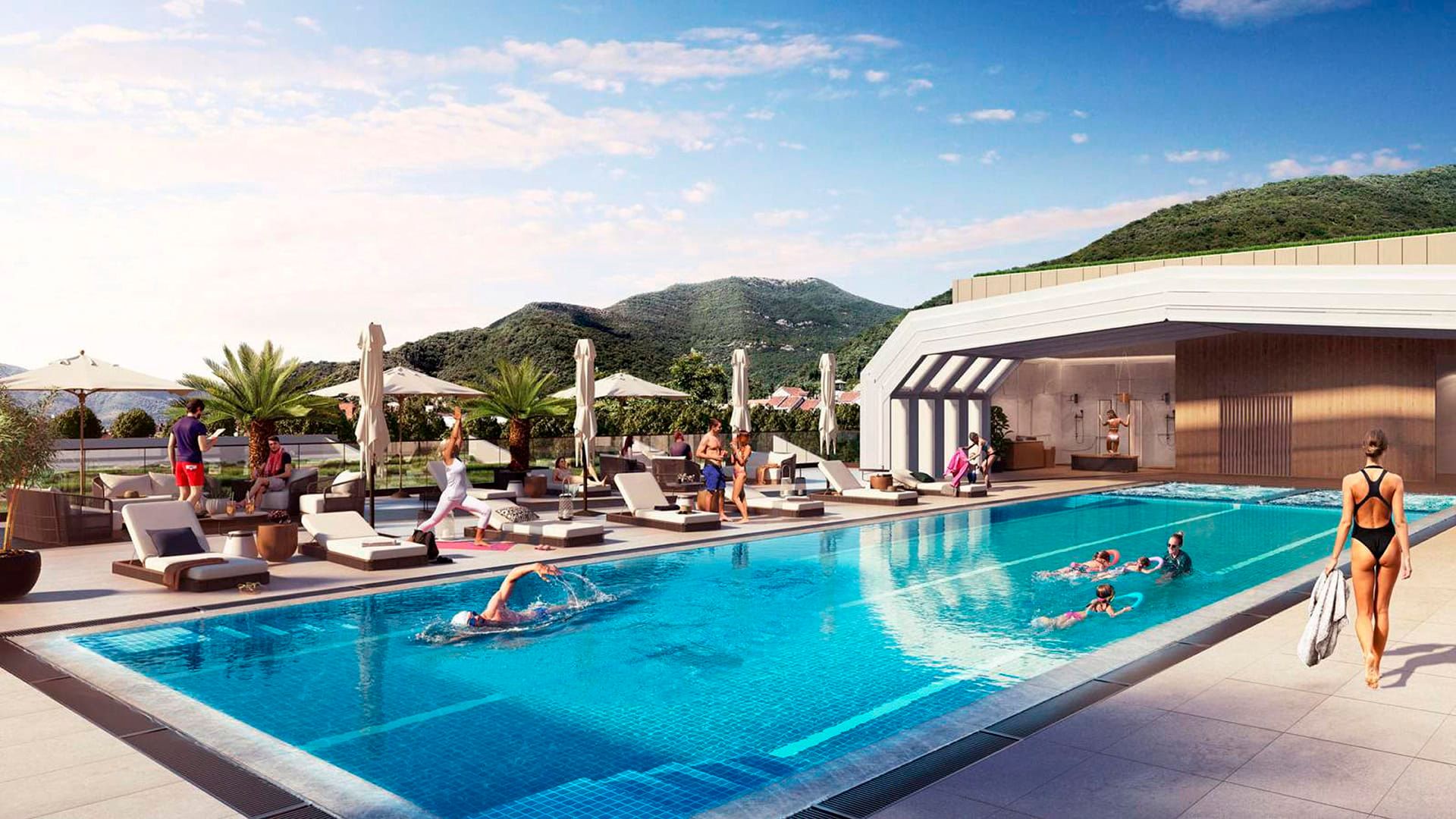 Open-air pool at Boka Place hotel, Tivat, Montenegro: sun loungers, terrace, and mountain views for guests to relax.