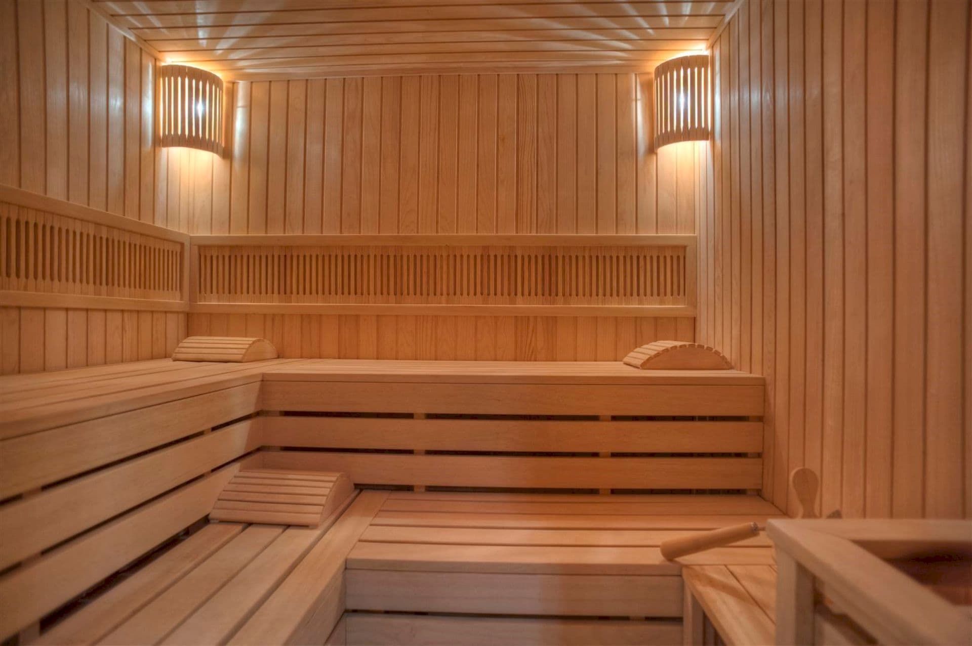 Modern wooden sauna with lighting in a villa in Krašići, Montenegro: light wood finish and benches.