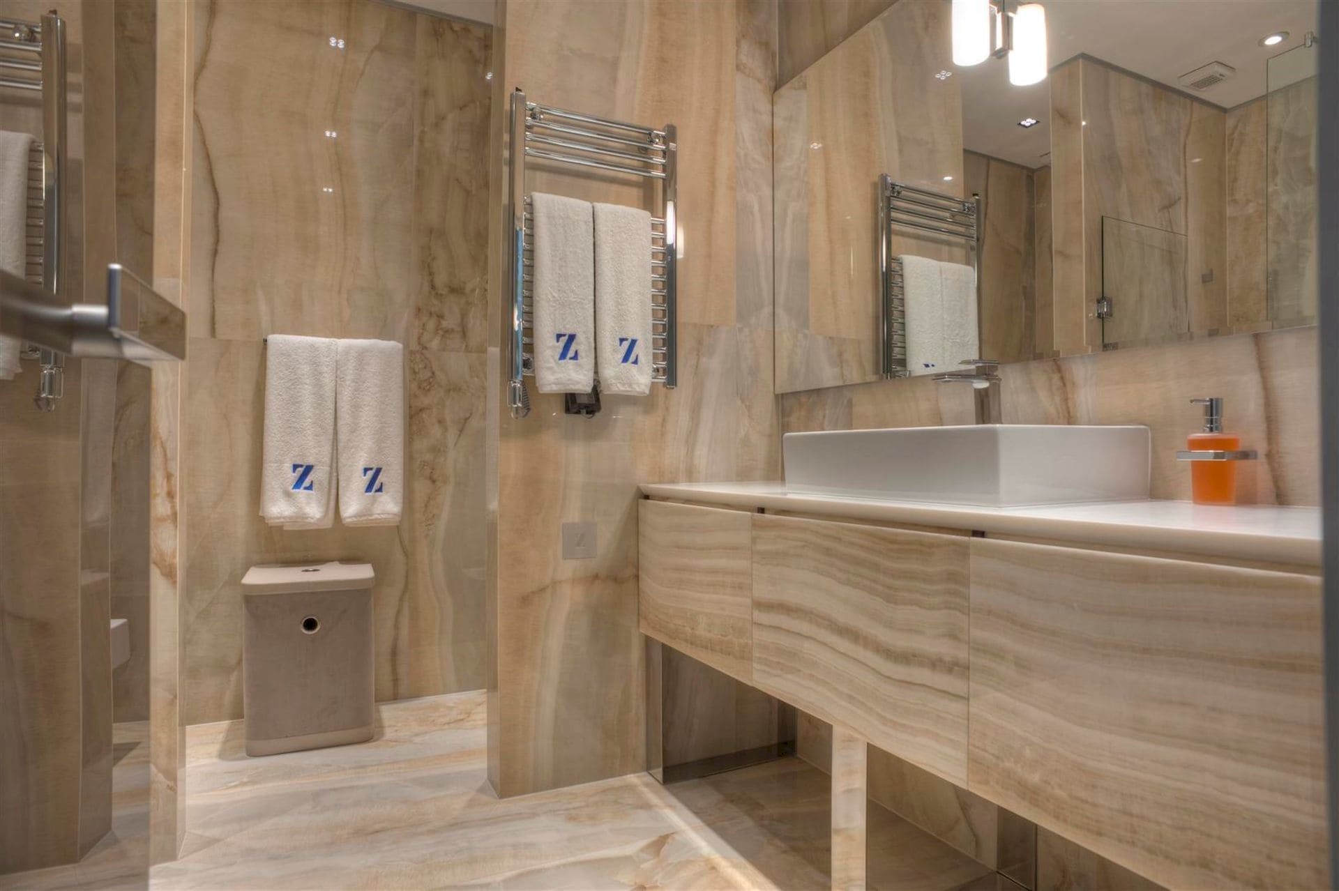Modern bathroom with beige marble finishes in a villa in Krašići, Montenegro: sink and stylish decor.