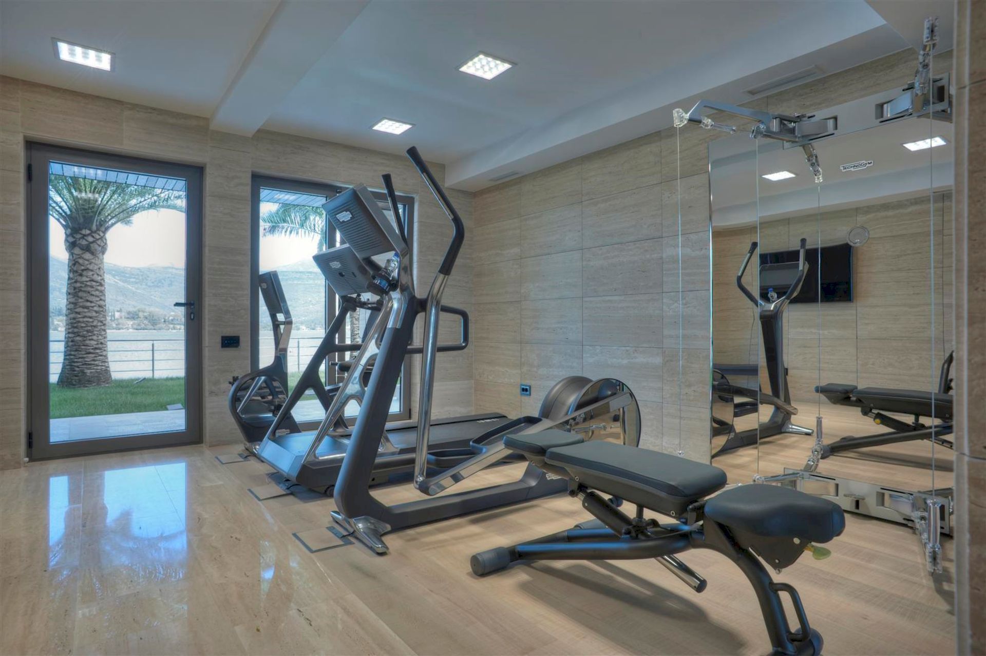 Modern gym in a villa in Krašići, Montenegro, with panoramic sea views and professional equipment.