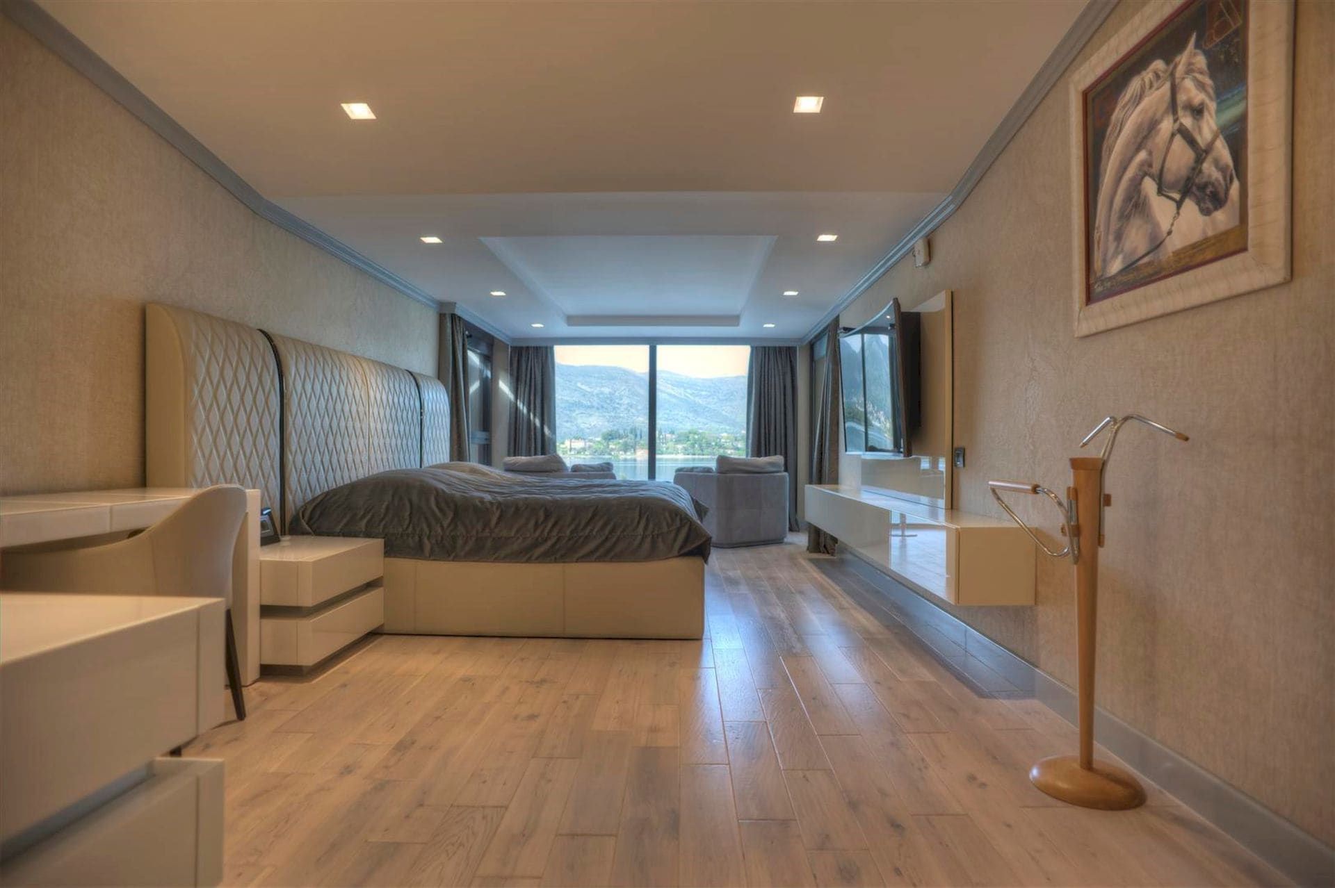 Modern bedroom with panoramic sea view in a villa, Krašići, Montenegro: double bed and stylish interior.