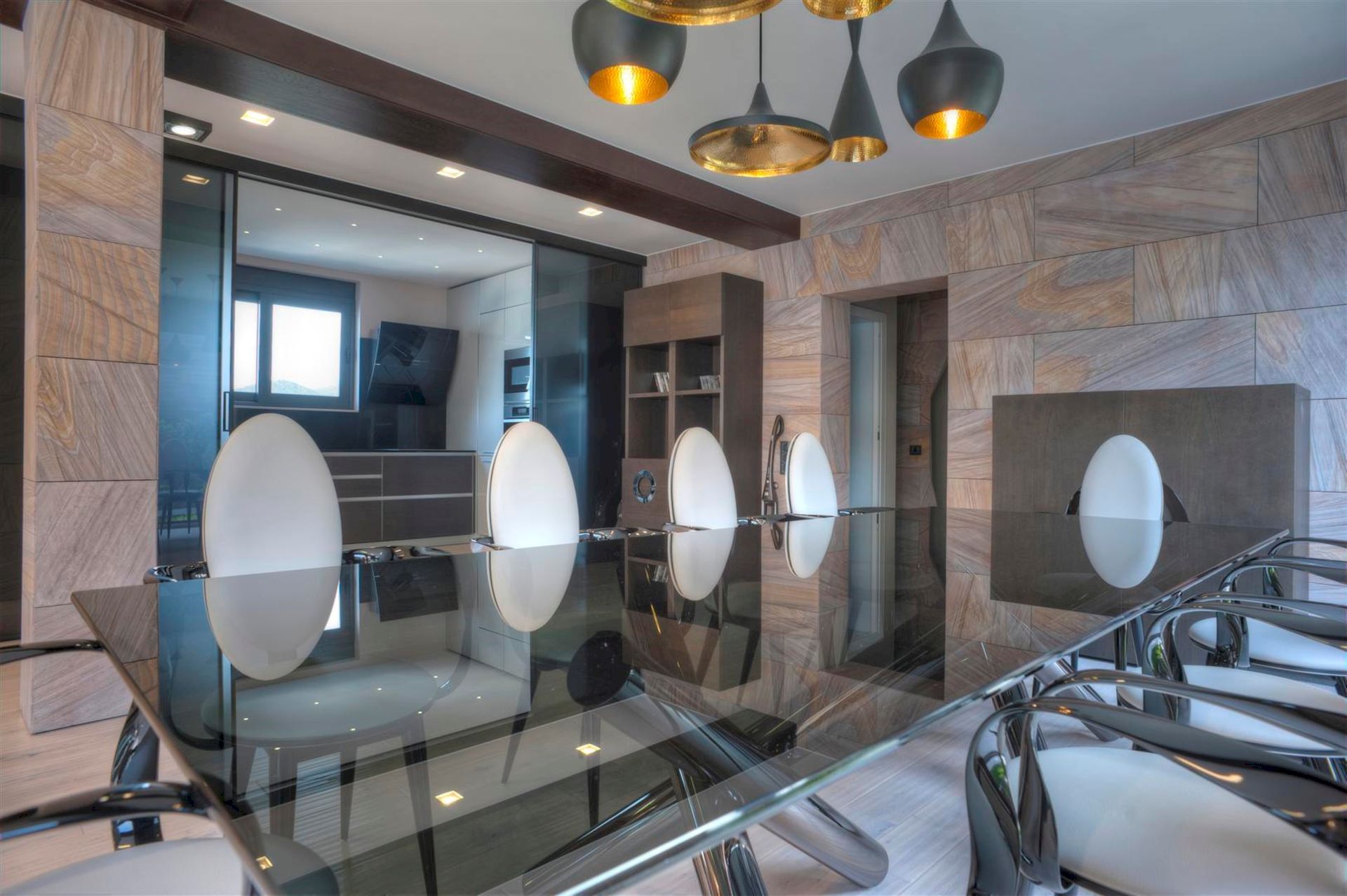 Modern living room with dining area in a villa in Krašići, Montenegro: glass table, designer chairs, and decor.