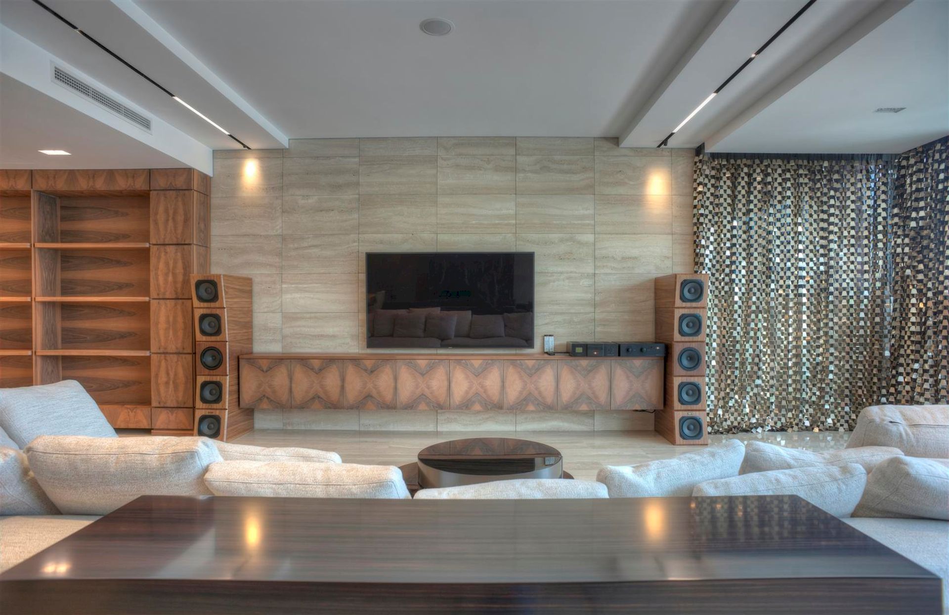 Villa living room in Krašići, Montenegro: designer wooden furniture, stone wall finishes, and a powerful audio system.