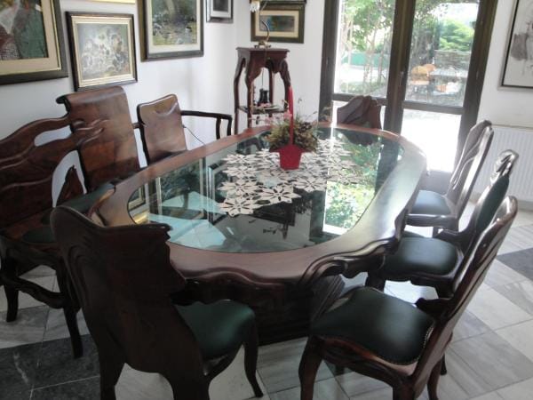 Dining area with a carved wooden table and chairs in a classic style in a house, Bar, Montenegro.