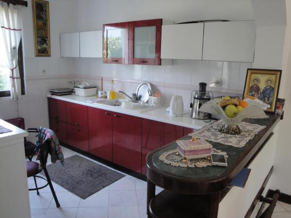 Kitchen with a red-and-white set and a bar counter in a house for sale, Bar, Montenegro.
