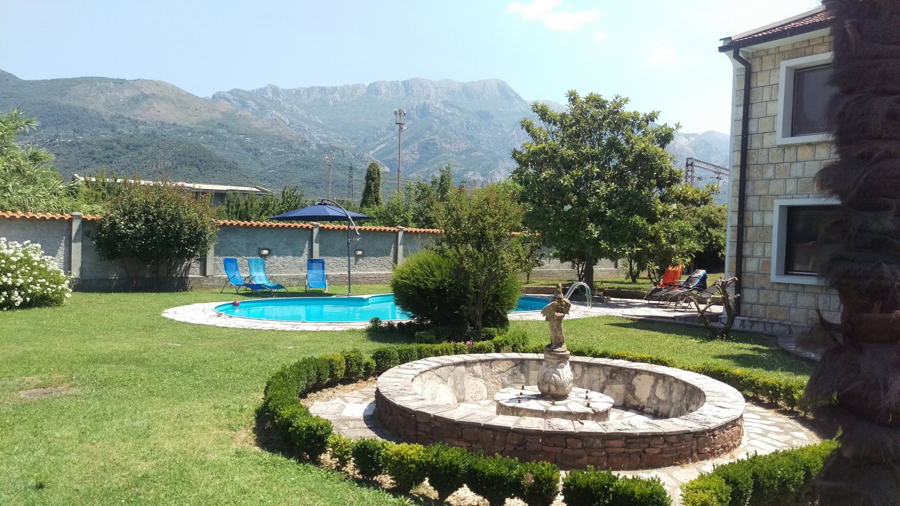 Private house with a pool and a stone fountain in the garden, mountain view, Bar, Montenegro.