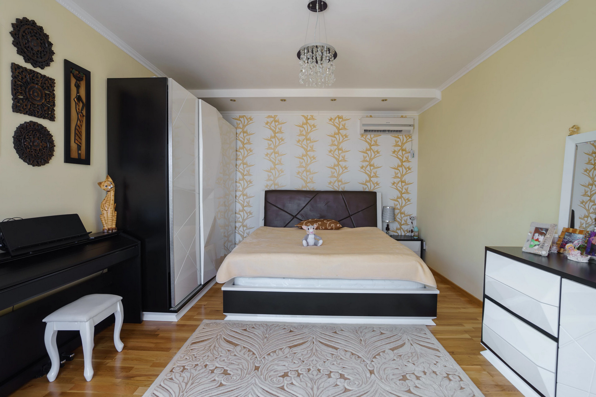 Cozy bedroom with a double bed and furniture in a house, Sutomore, Montenegro. Parquet flooring, decor, and air conditioning.