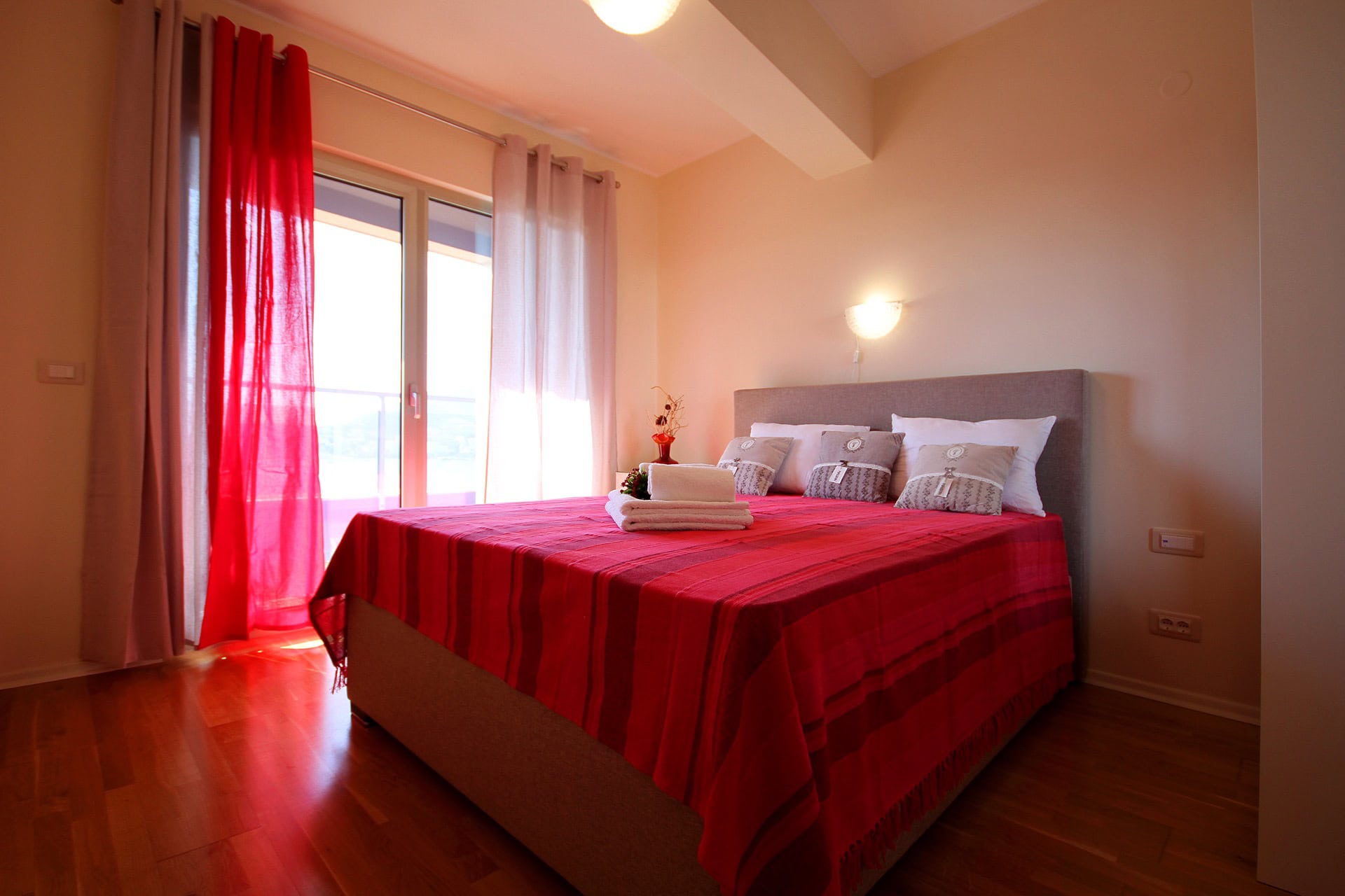 Cozy bedroom with a double bed and access to the balcony in an apartment, Becici, Montenegro.