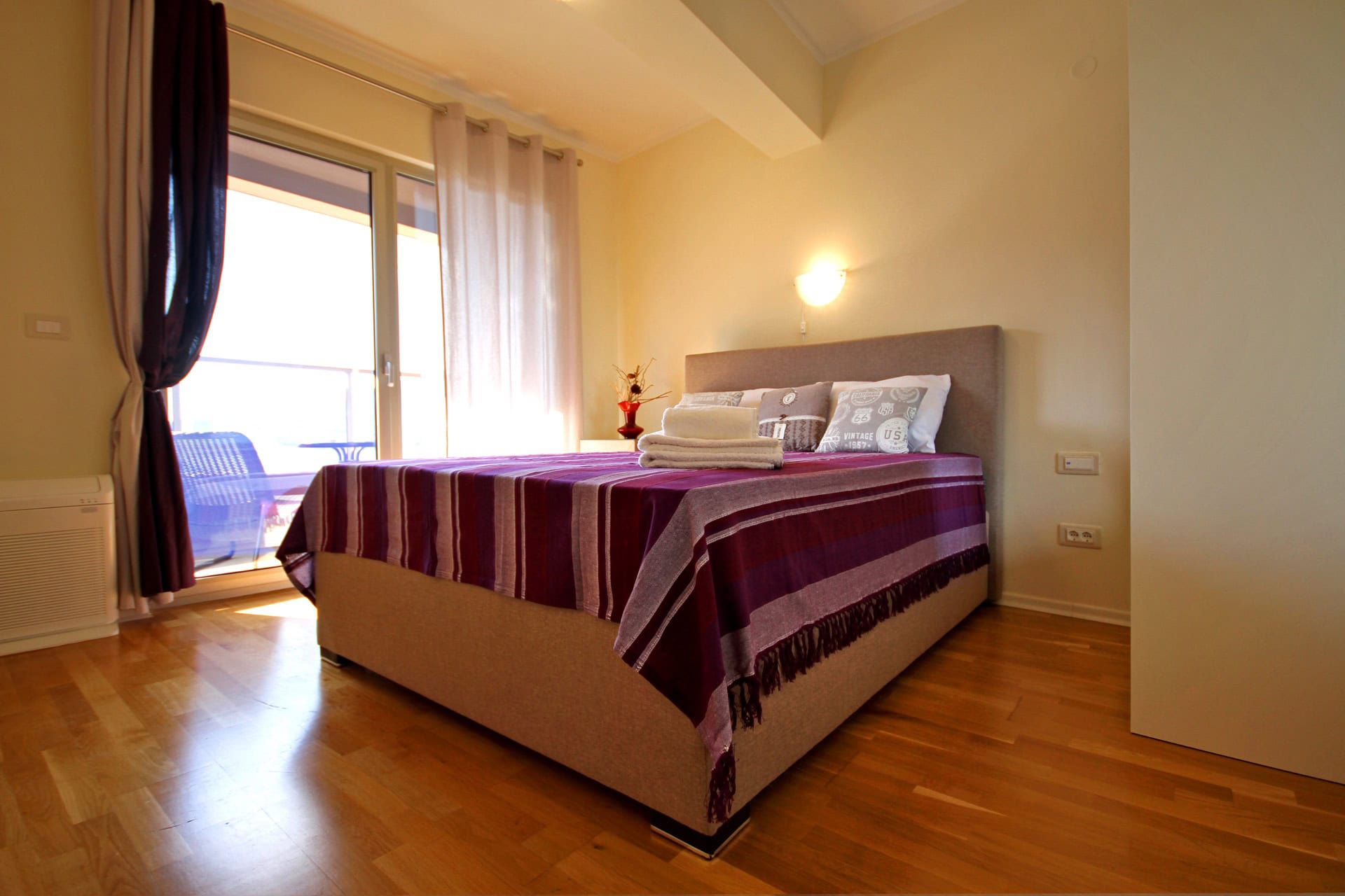 Cozy bedroom with a double bed and access to the balcony in an apartment, Becici, Montenegro.