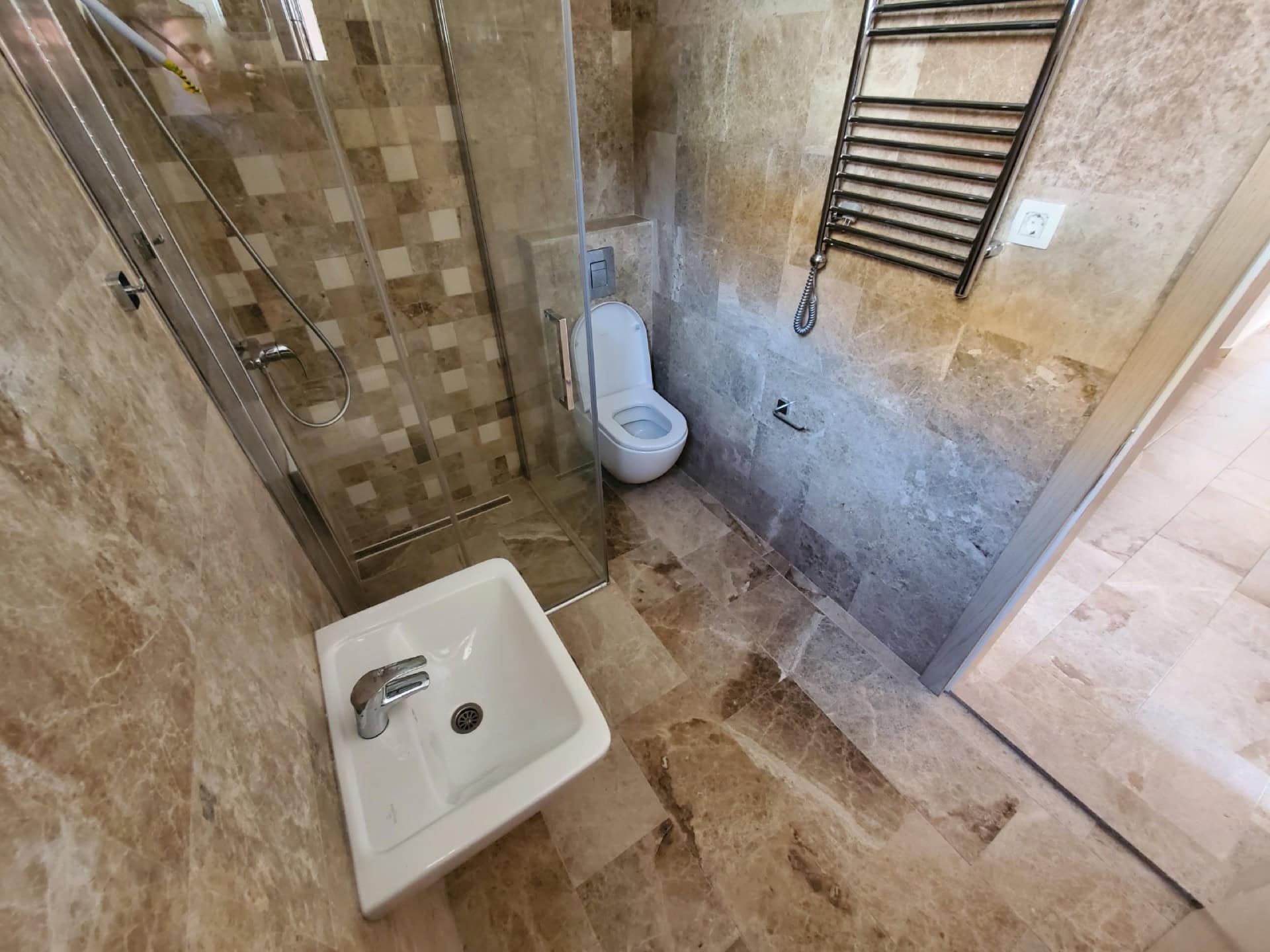 Modern bathroom with a shower cabin and stone finishes in a penthouse, Pržno, Montenegro.