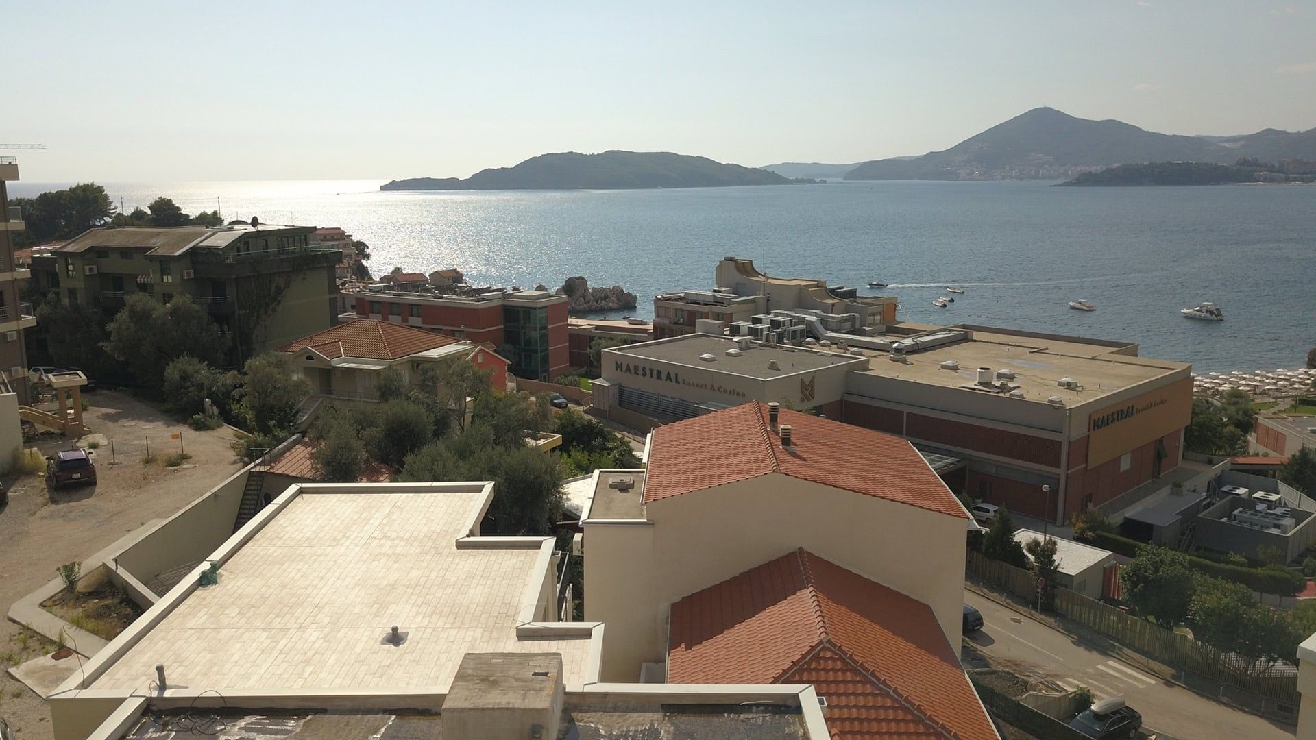 Panoramic sea view and Maestral Hotel from a penthouse in Pržno, Montenegro: rooftops and seascape.