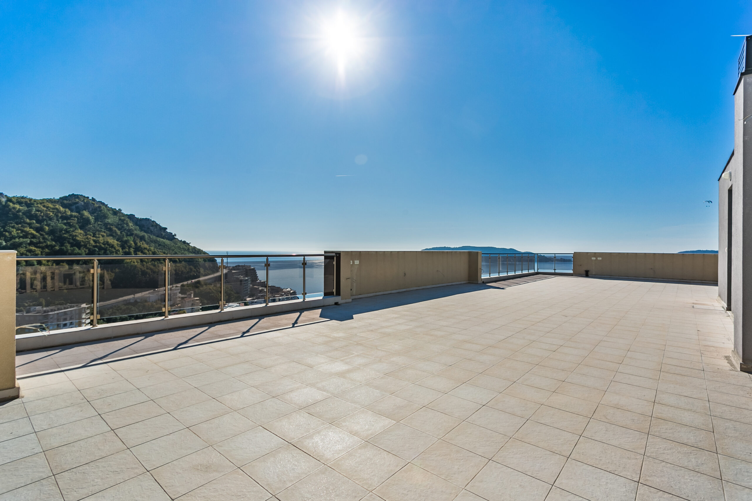Spacious open penthouse terrace in Rafailovici, Montenegro, with panoramic sea and mountain views.