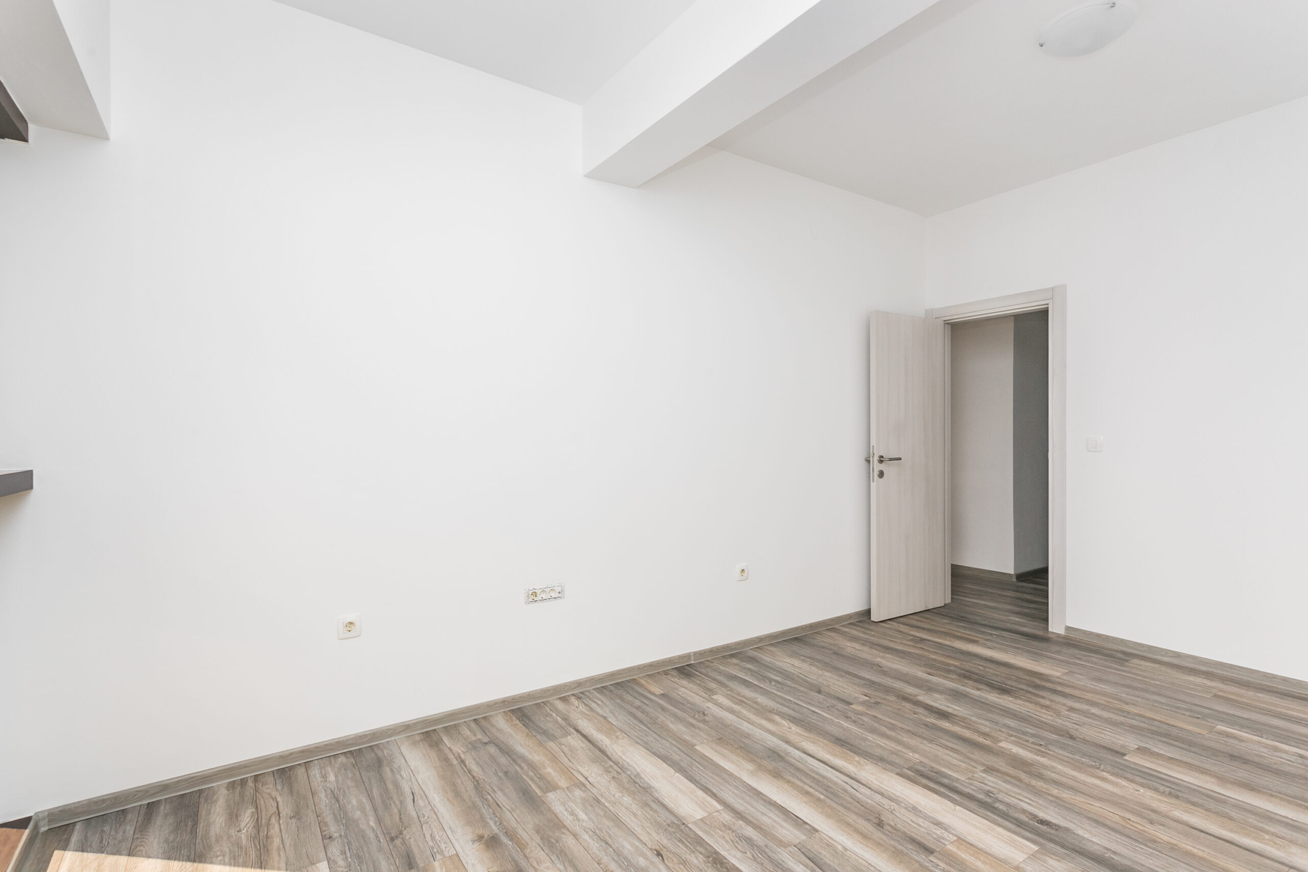 Bright living room with wood finishes in a penthouse, Rafailovici, Budva Riviera, Montenegro.