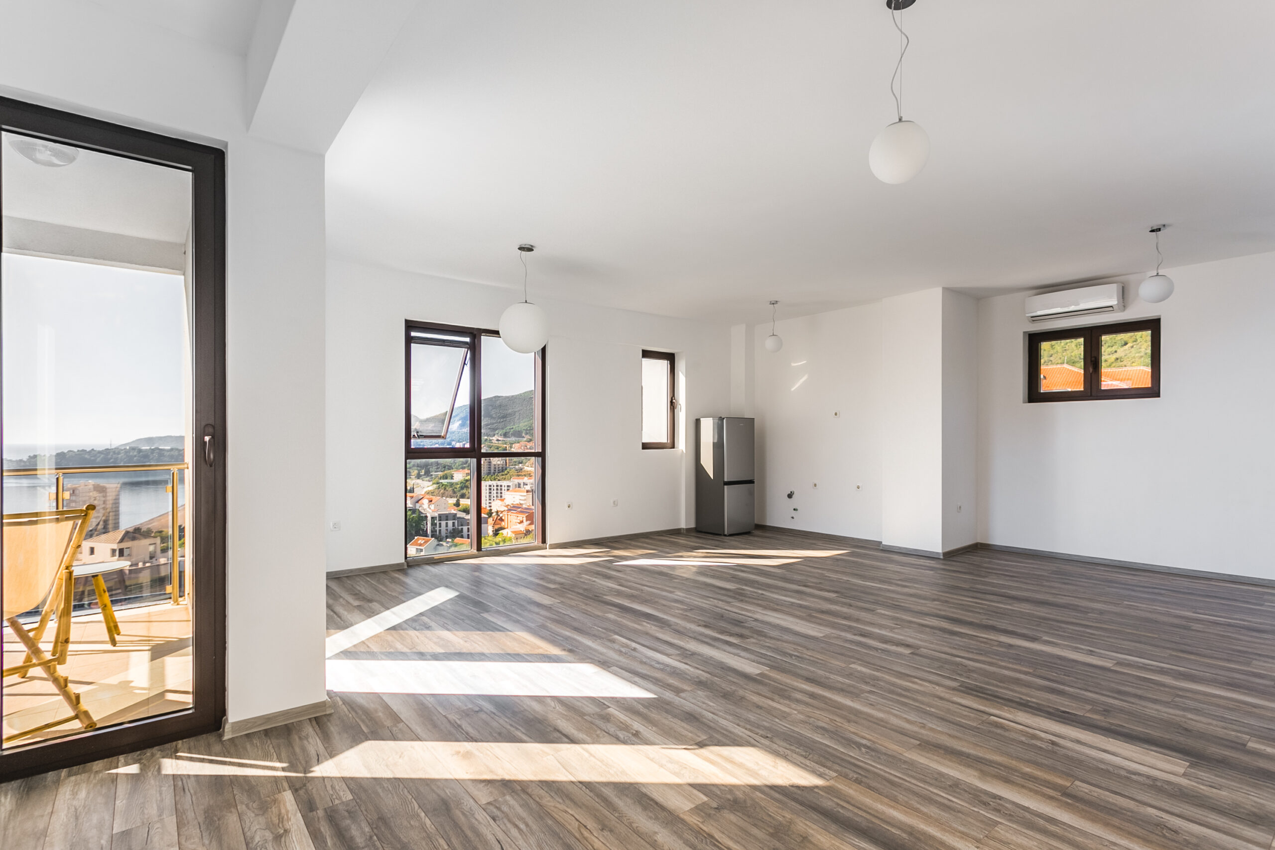 Bright living room in a penthouse, Rafailovici, Montenegro: panoramic sea view, terrace, and modern finishes.