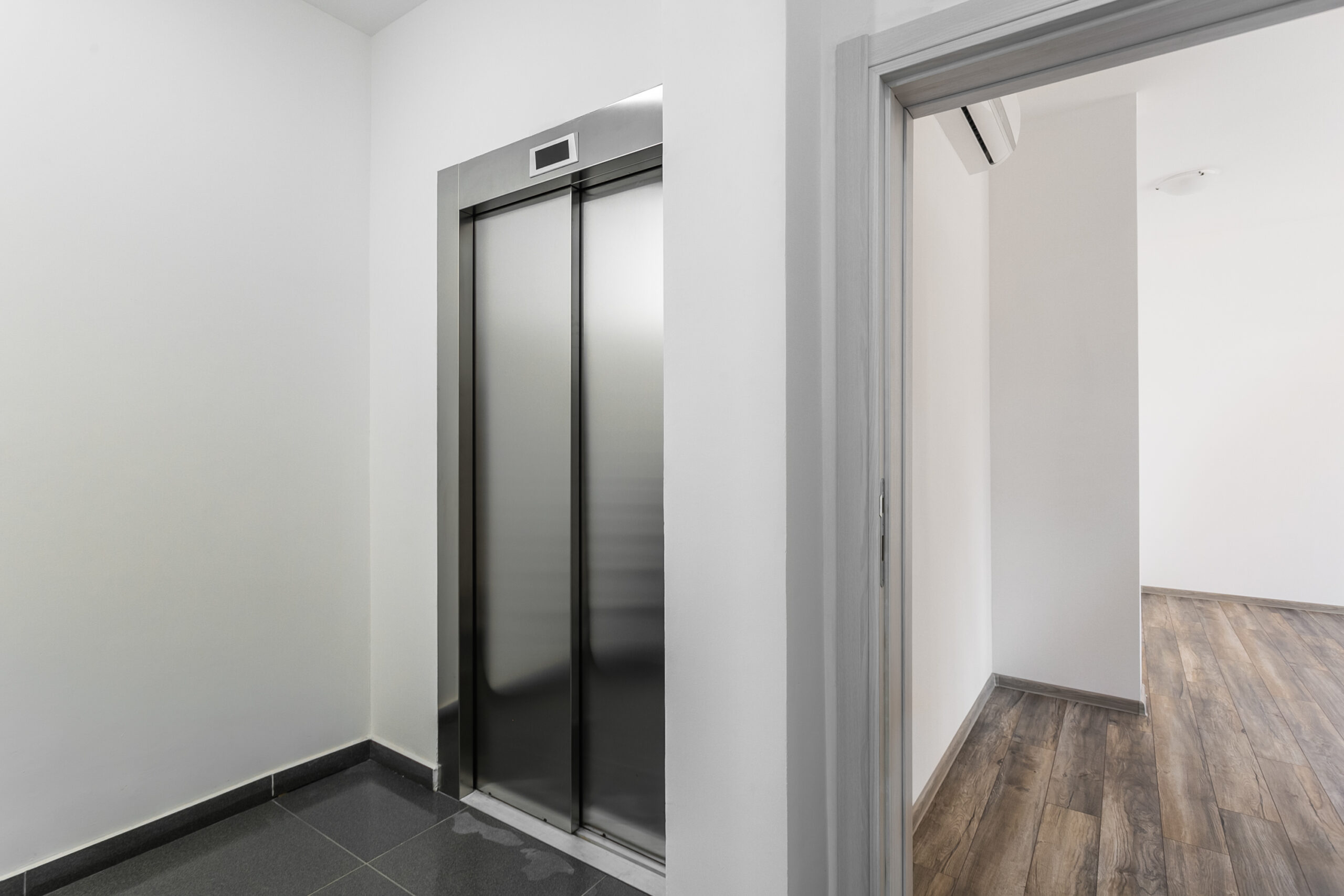 Modern elevator and apartment entrance with finishes in a penthouse, Rafailovici, Budva Riviera, Montenegro.