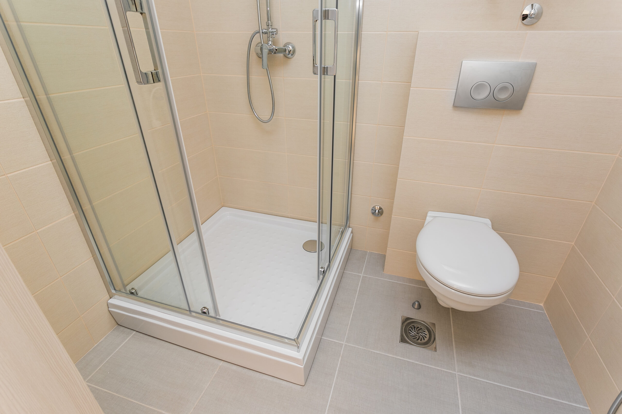 Modern bathroom with a shower cabin and wall-hung toilet in a penthouse, Rafailovici, Montenegro.