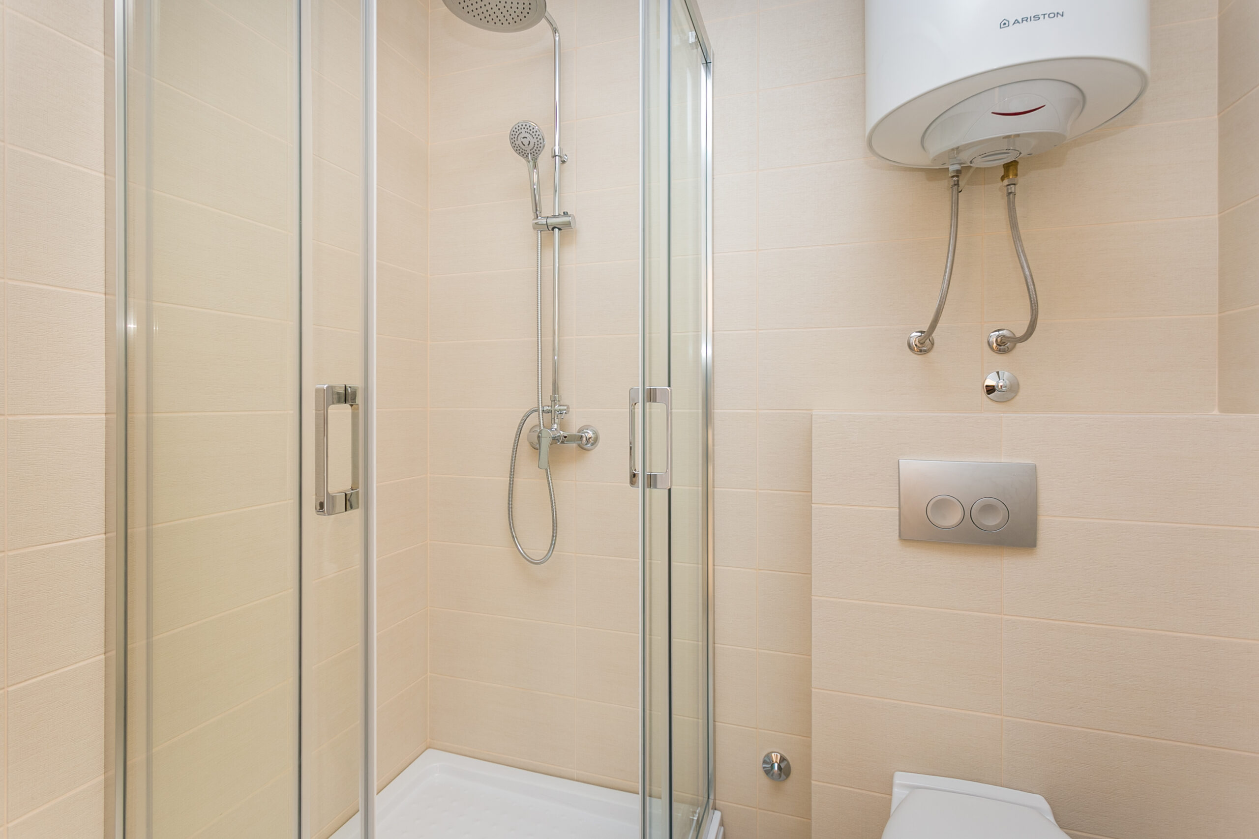 Modern bathroom with a shower cabin and boiler in a penthouse, Rafailovici, Budva Riviera, Montenegro.