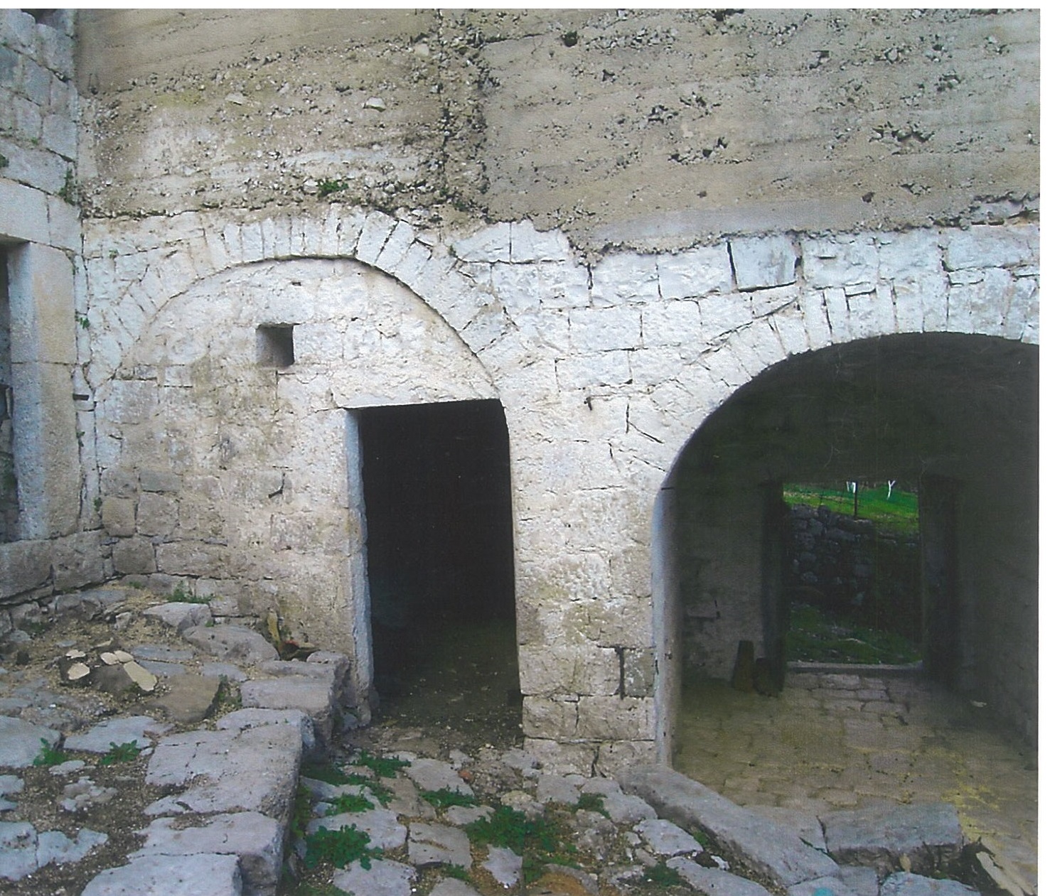 An old stone building for reconstruction on a plot in Lučići, Herceg Novi, Montenegro: view of the arched openings.