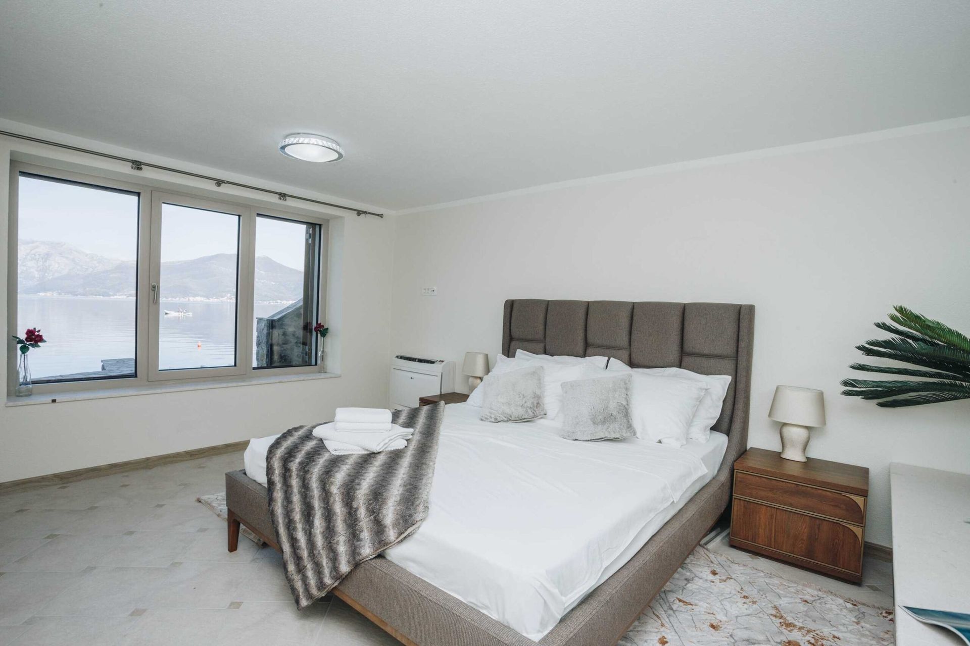 Bedroom in a villa in Krašići, Montenegro: double bed, modern furniture, and panoramic sea and mountain views.