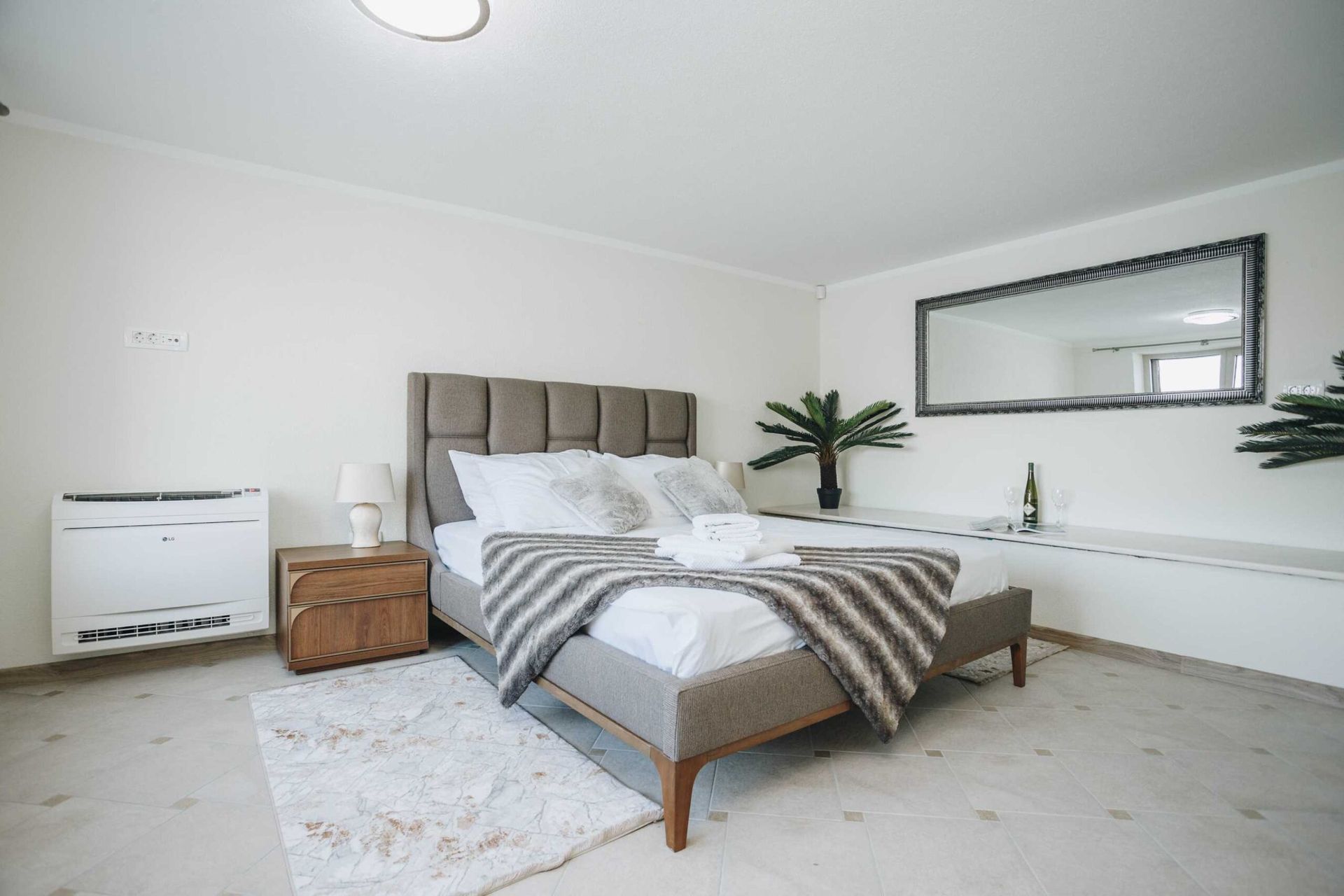 Cozy bedroom with a double bed in a villa in Krašići, Montenegro: modern furniture, light finishes, and decor.