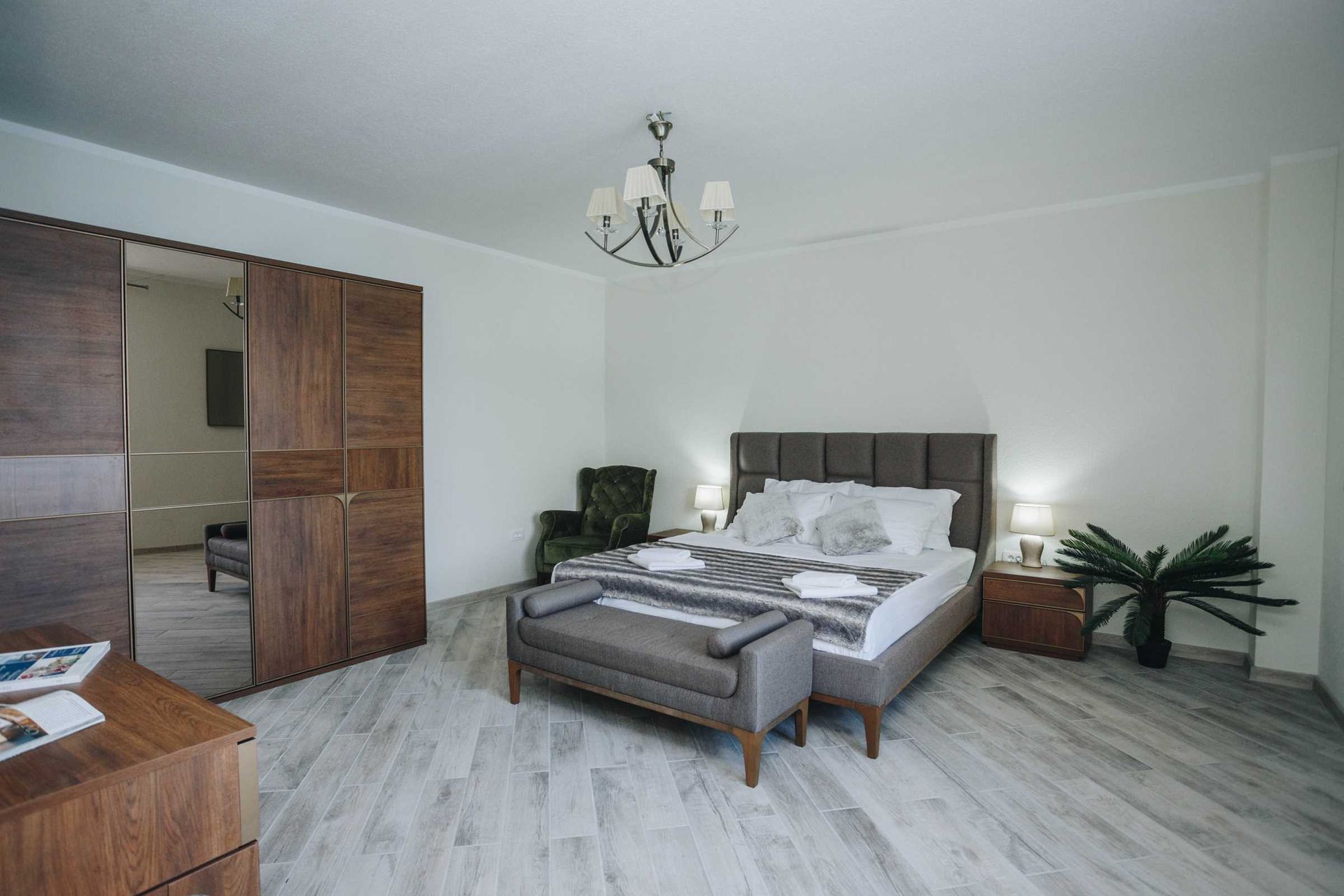Cozy bedroom with a double bed and wooden furniture in a villa in Krašići, Montenegro. Modern interior.