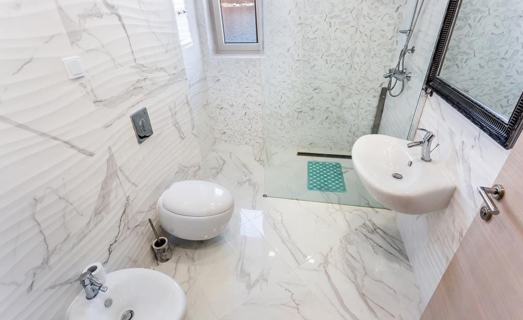 Modern bathroom with marble-style finishes and a shower cabin in a villa in Krašići, Montenegro.