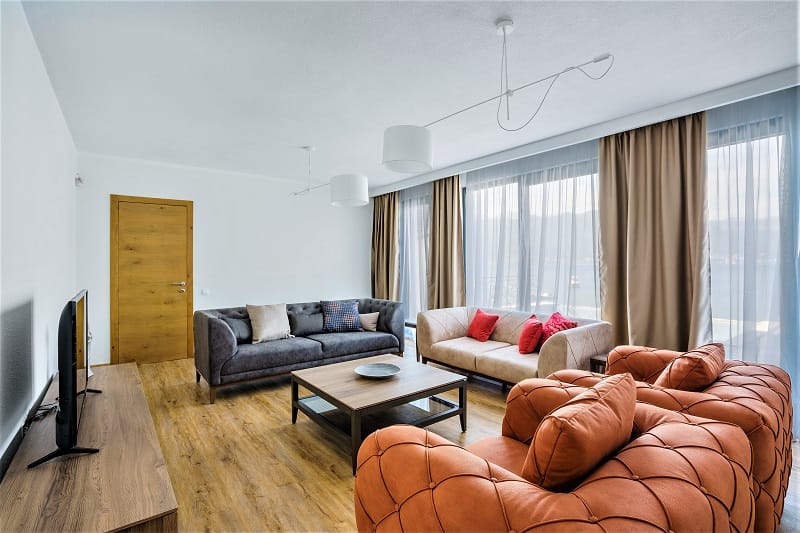 Modern living room with soft seating and panoramic sea view in a villa, Krašići, Montenegro.