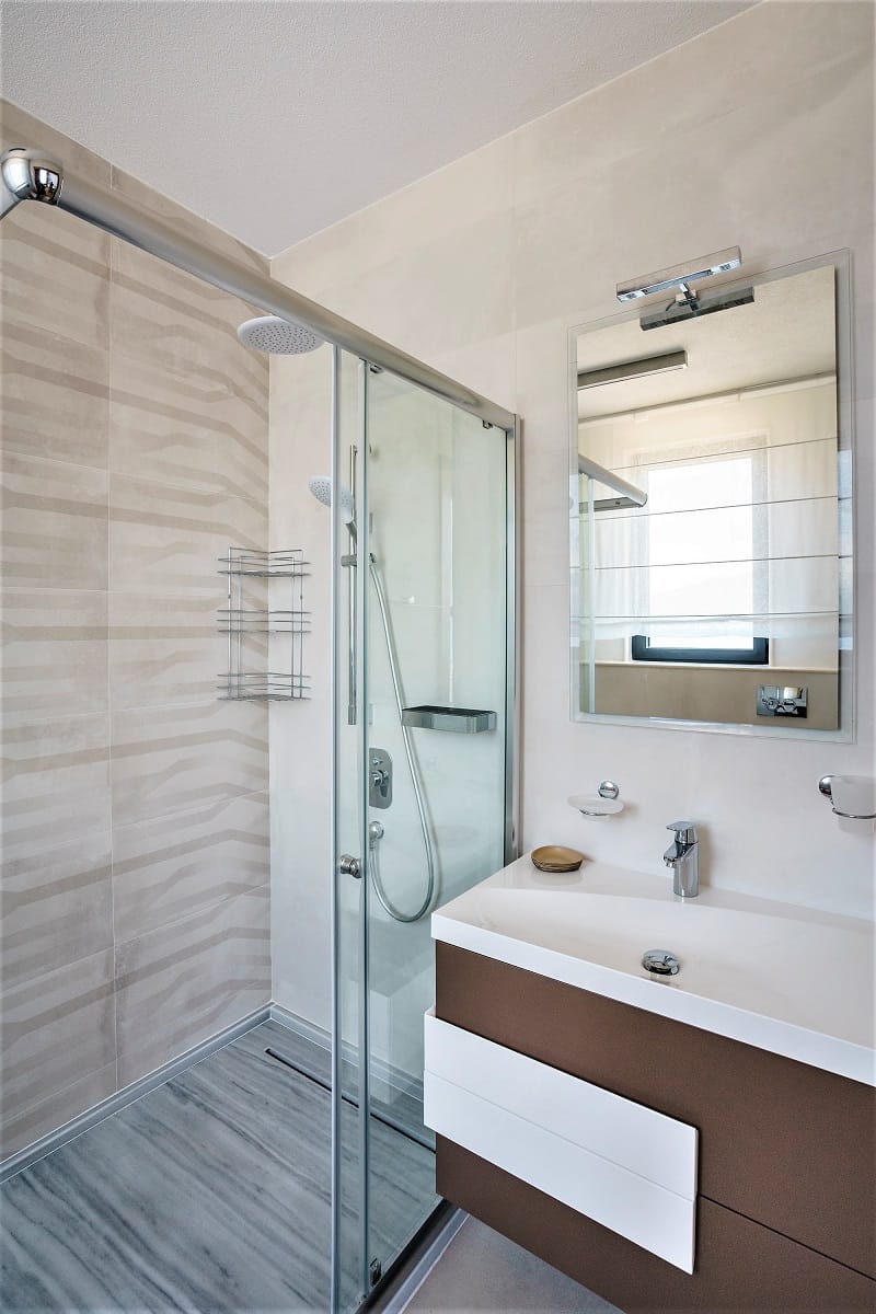 Modern bathroom with a shower cabin in a villa in Krašići, Montenegro: stylish finishes and fixtures.