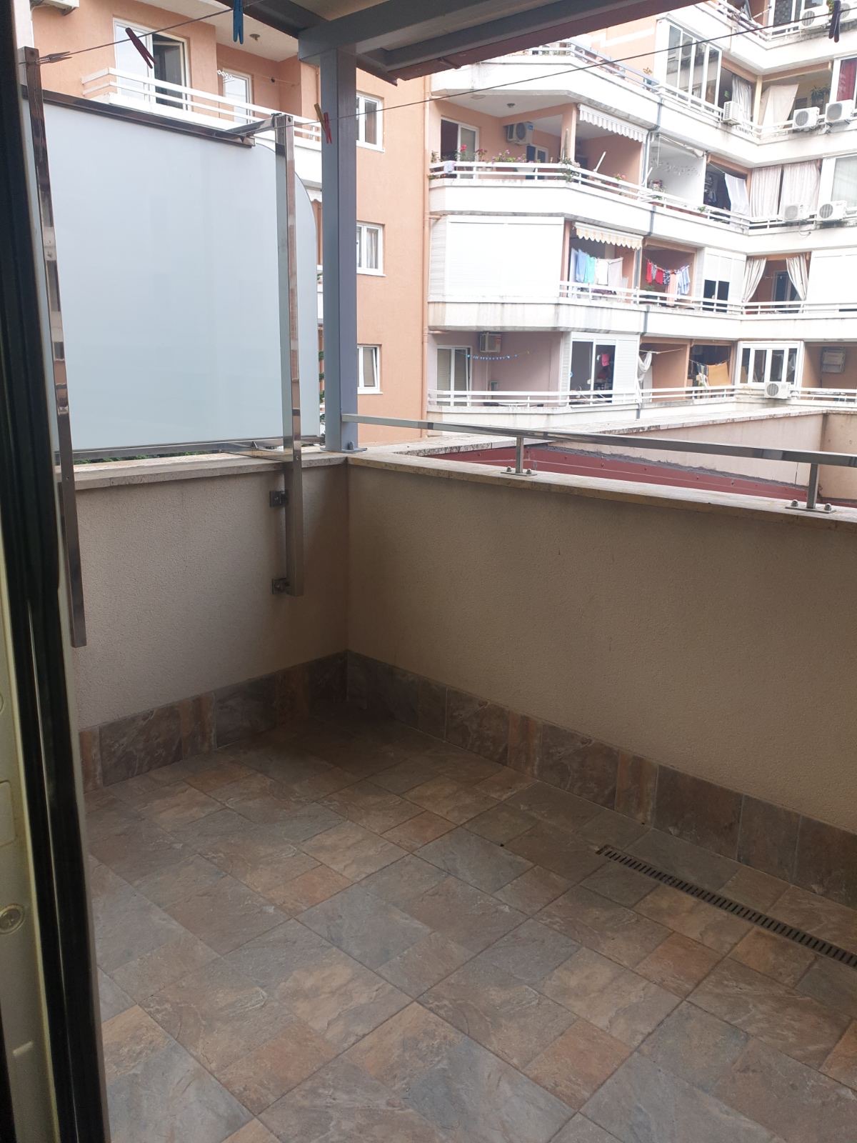 Open balcony with tiled finish in an apartment in Budva, Montenegro, overlooking neighboring residential buildings.