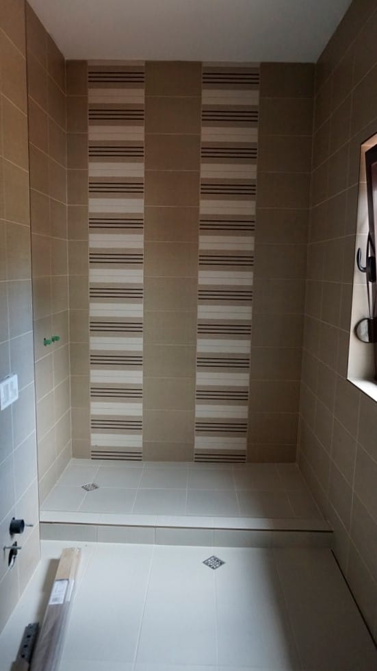 Bathroom with a shower area and beige tiles in a villa in Igalo, Montenegro: modern interior finish.