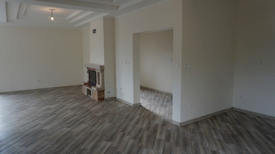 Spacious living room with a fireplace and wood finishes in a villa in Igalo, Herceg Novi, Montenegro.