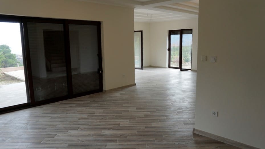 Spacious living room with panoramic windows and light finishes in a villa in Igalo, Montenegro.