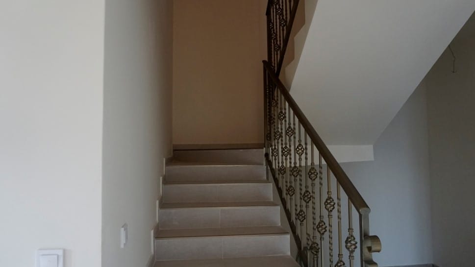 Staircase with wrought-iron railings in the interior of a villa in Igalo, Herceg Novi, Montenegro. Modern finish in light tones.