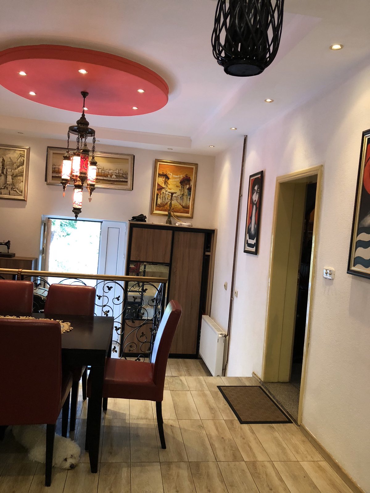 Living room in the Zelenika mini-hotel, Herceg Novi, Montenegro: dining area with red chairs and oriental lighting.