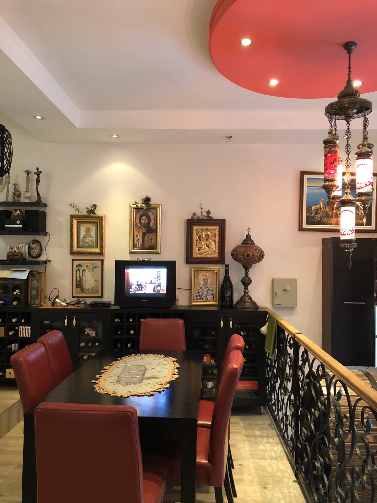 Living room in the Zelenika mini-hotel, Herceg Novi, Montenegro: dining area with red chairs and wrought-iron railings.