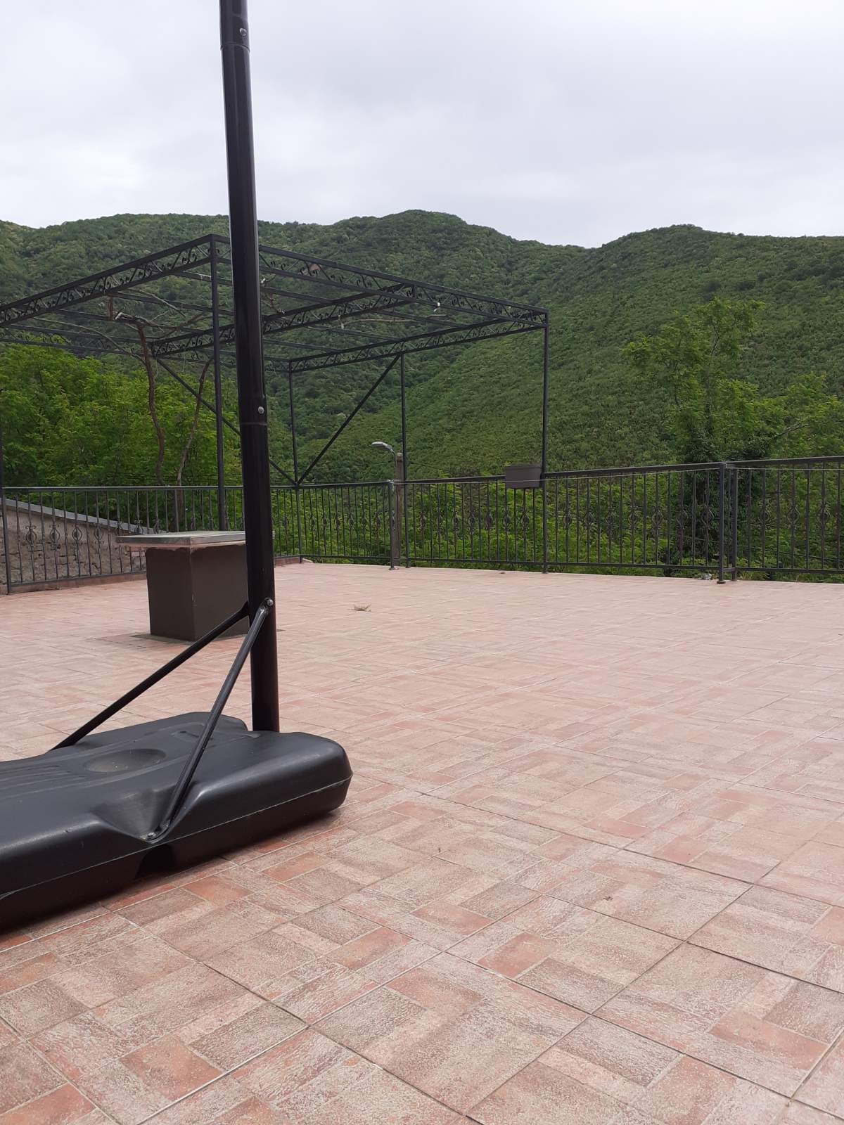 Open terrace with mountain views at the Zelenika mini-hotel, Herceg Novi, Montenegro: tiled flooring and an awning.