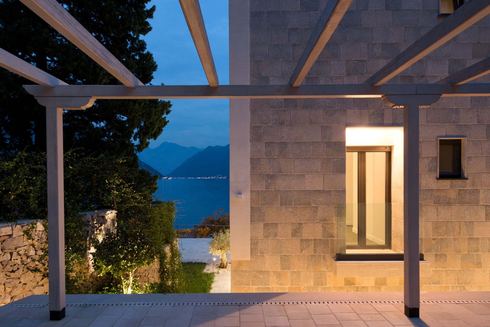 Stone villa in Strp, Montenegro: view from the pergola terrace of the sea and mountains in the evening.