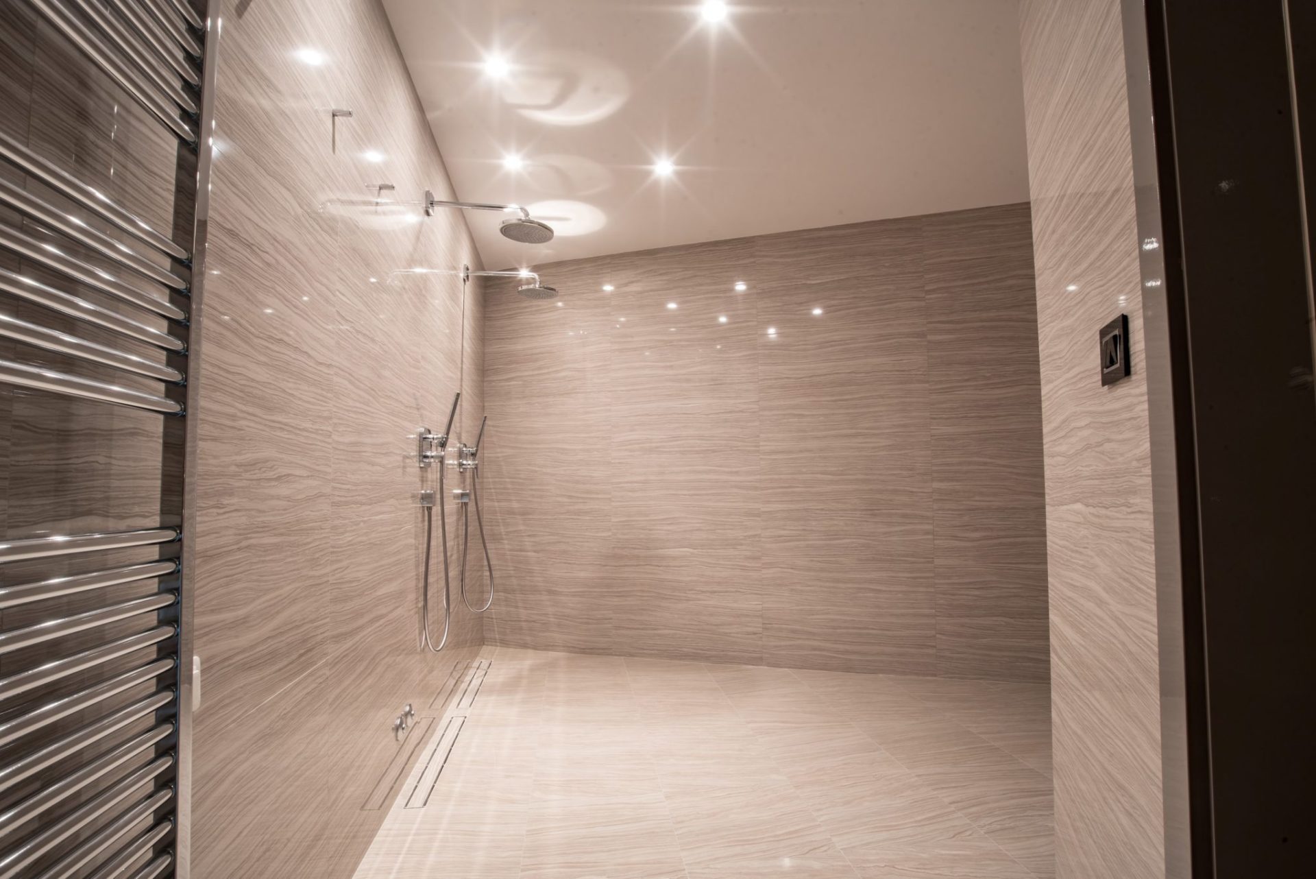 Modern bathroom with a shower area and beige tile finishes in a luxury villa, Budva, Montenegro.
