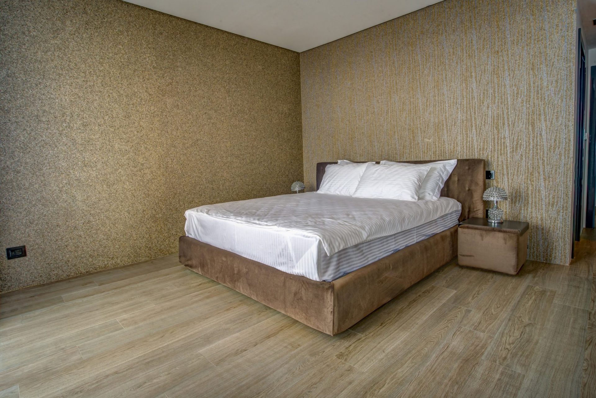 Modern bedroom with a double bed and designer wall finishes in a villa, Budva, Montenegro.