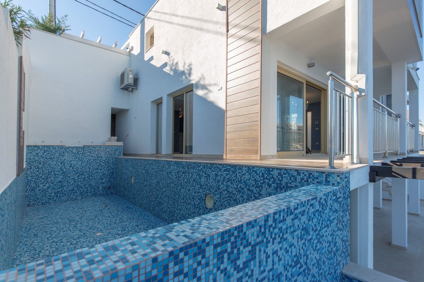 Modern villa in Krašići, Montenegro: private pool with blue mosaic finish and a terrace with panoramic views.